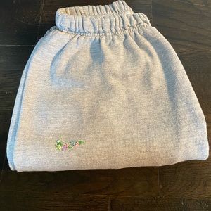 Grey Embroidered Nike sweatpants.